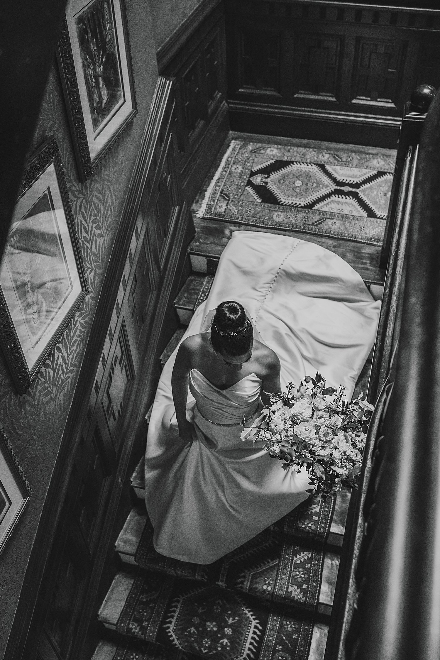 bride walks down carpeted stairs by Jen Harvey Photography