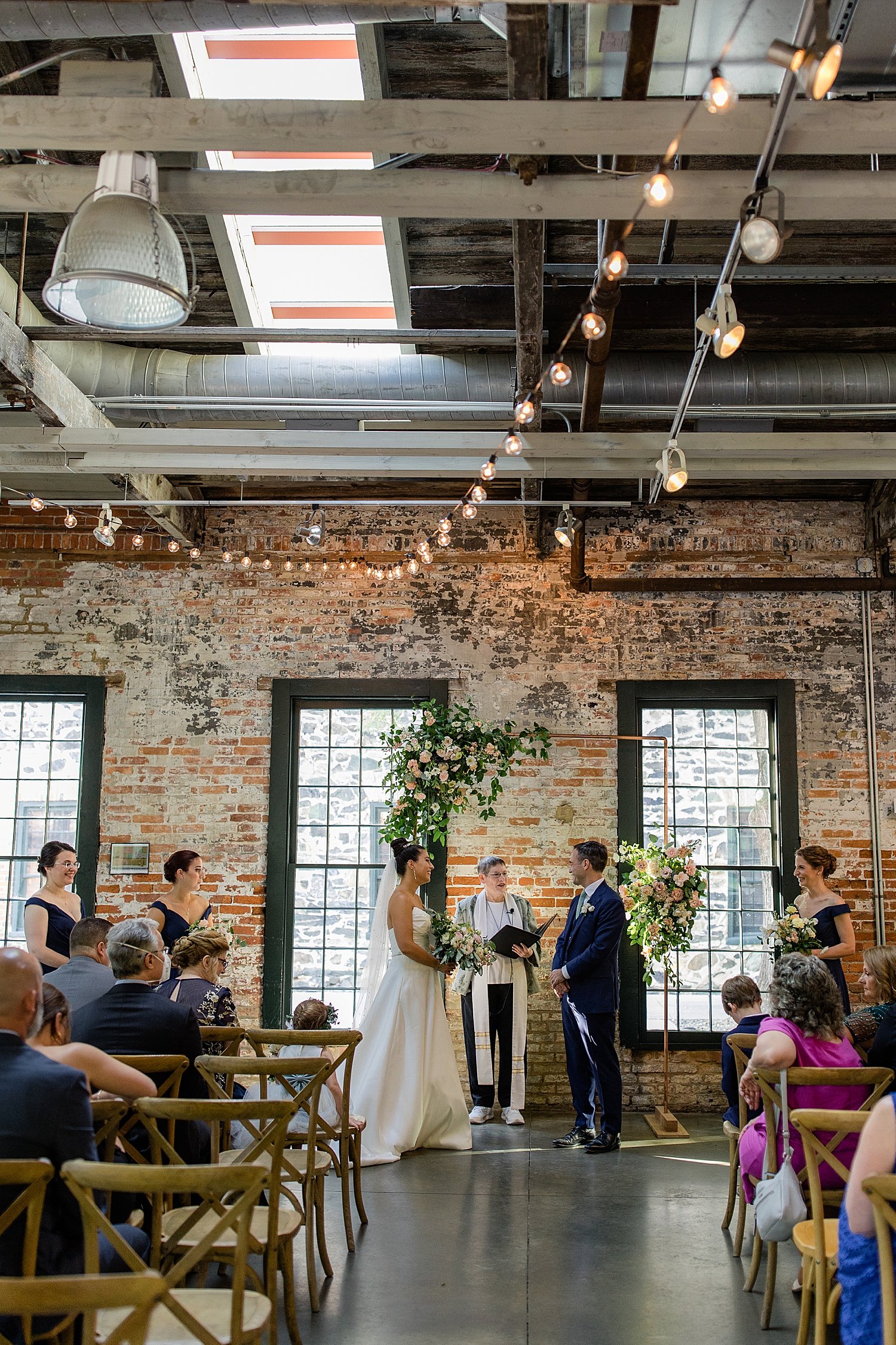 couple stands at alter to say I Do by Baltimore wedding photographer 