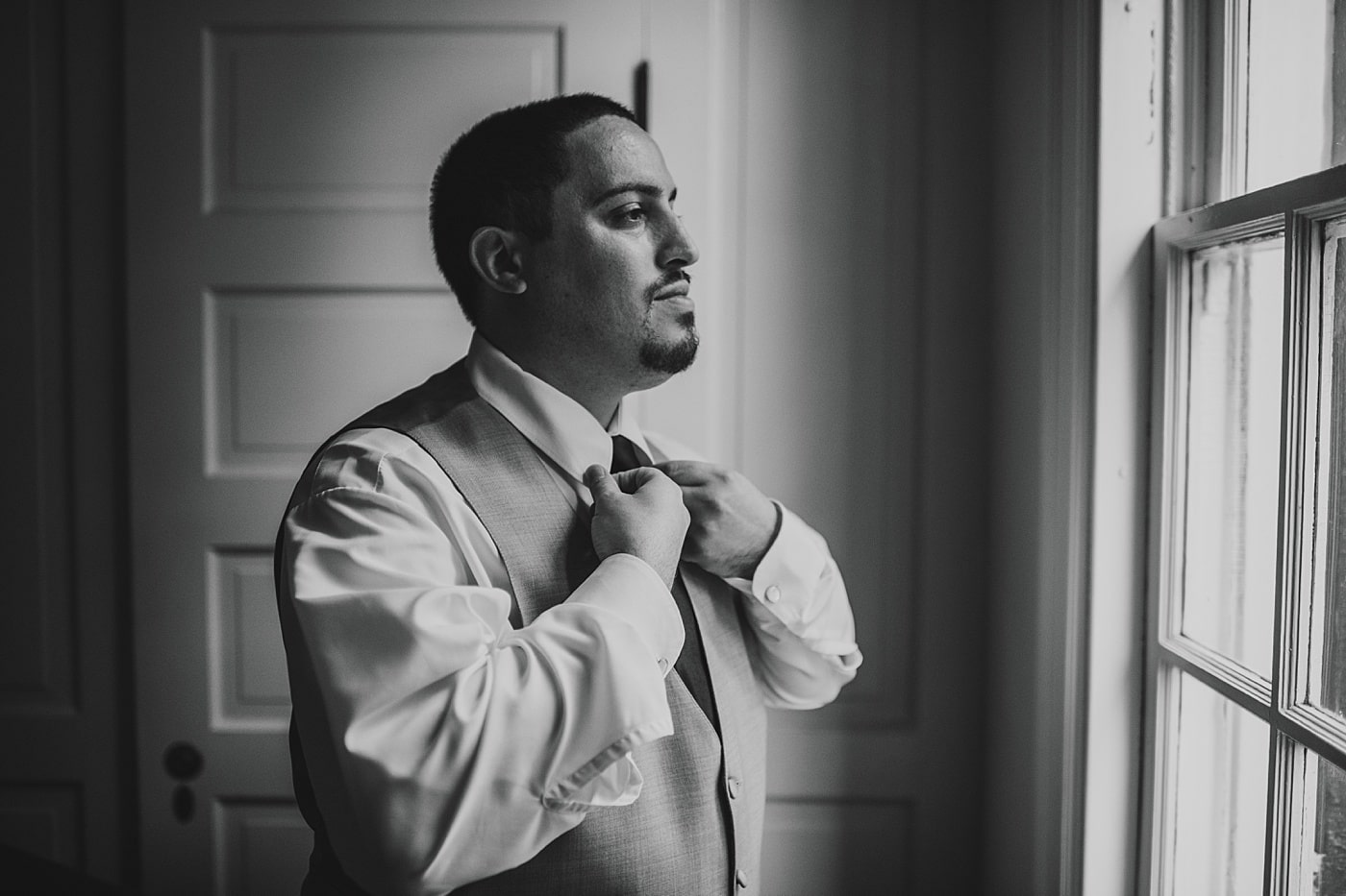 Groom getting ready on wedding day at Rust Manor House