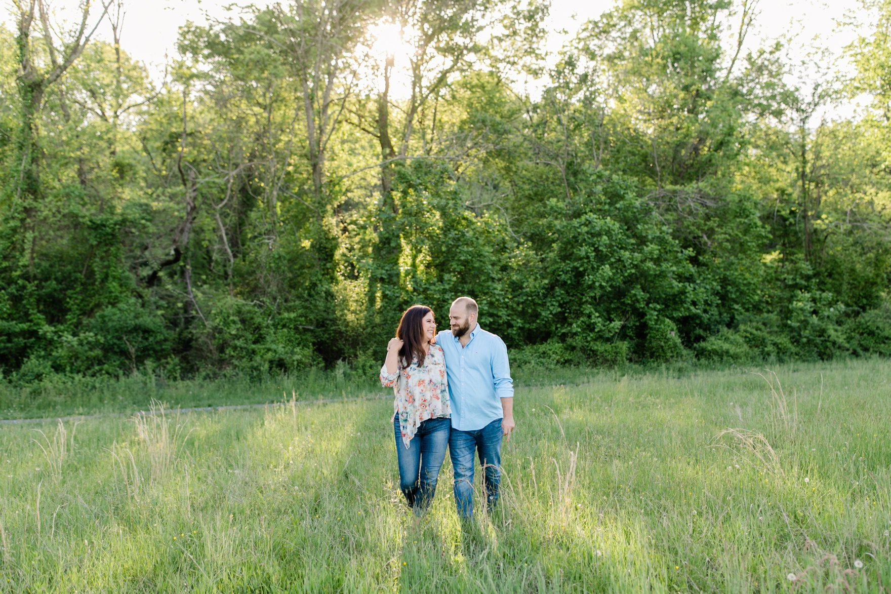 Couple walking together in a open field during sunset